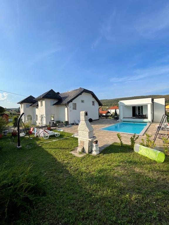 a house with a swimming pool in a yard at Villa Sami in Bihać