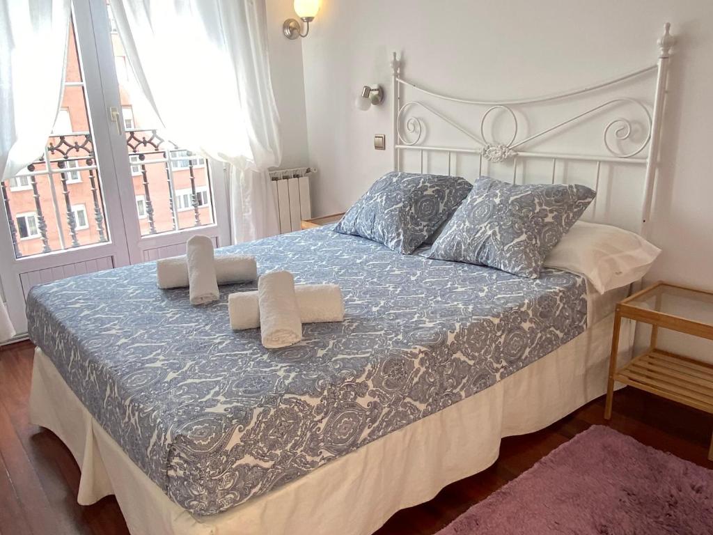 a bedroom with a bed with two towels on it at Apartamento céntrico, parking gratis in Santander