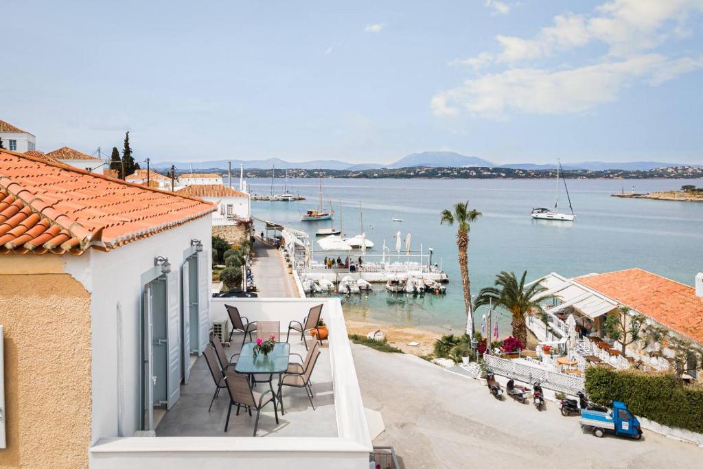 a balcony of a house with a view of the water at Aroura Maisonette Spetses 4BR in Spetses