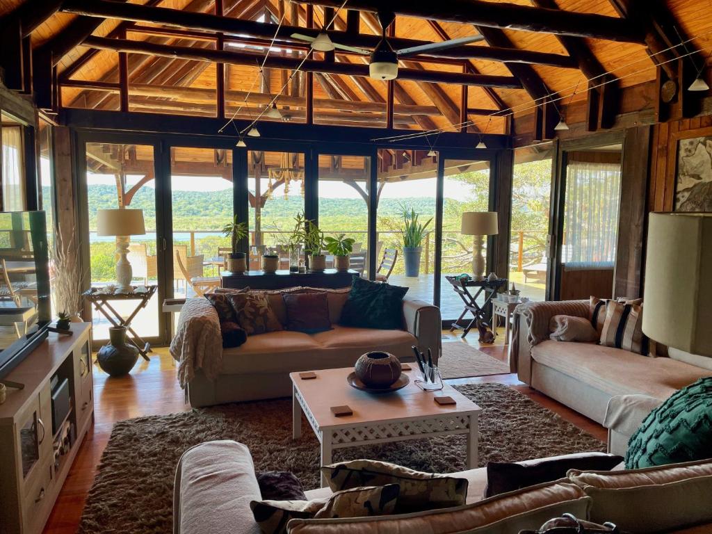 a living room with couches and a table at House 37 Nkululeko in Sodwana Bay Lodge in Sodwana Bay