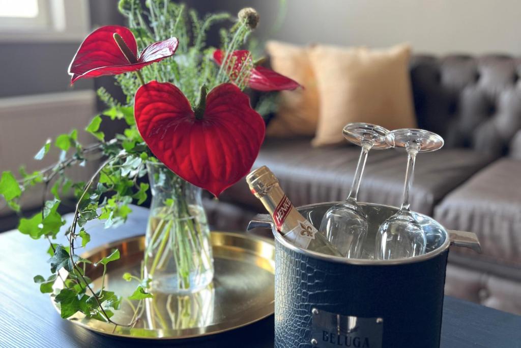 a table with a vase with a heart on it at Hotel Golden Circle Suites in Rovaniemi