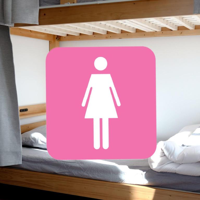 Postel nebo postele na pokoji v ubytování Matoi Hostel & Bar