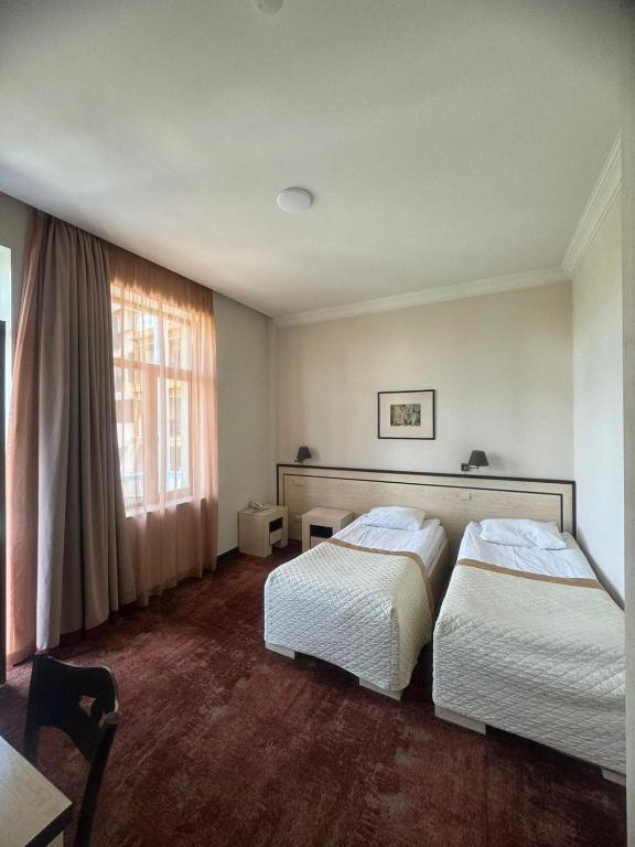 Postel nebo postele na pokoji v ubytování Hotel Beka Palace