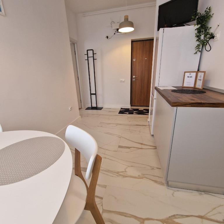 a kitchen with a table and a refrigerator at Apartament Marco 5 in Baia Mare