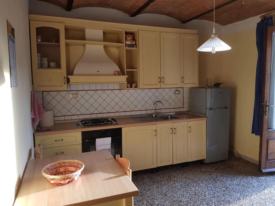 a kitchen with white cabinets and a counter top at Casa di Luca Catabbio in Catabbio