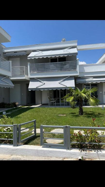 a large building with a fence in front of it at Palm Residential in Orfánion
