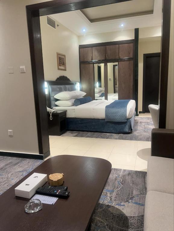 a hotel room with a bed and a desk in a room at AG Hotel in Abu Dhabi