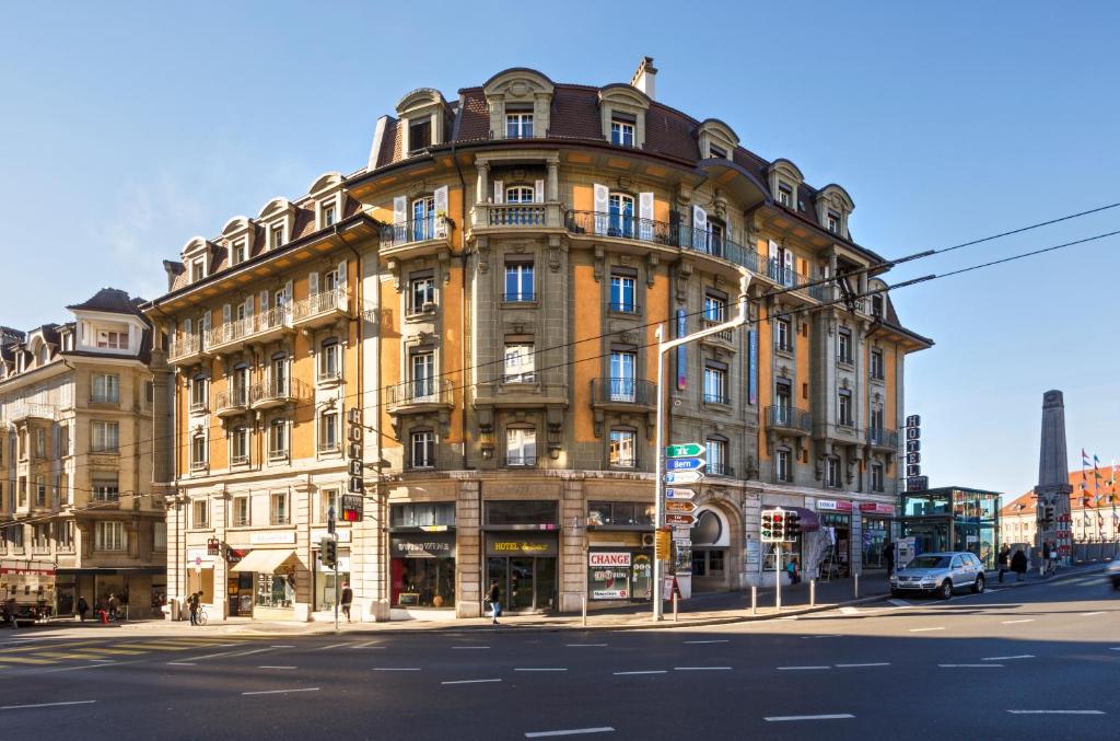 a large building on the corner of a street at Swiss Wine by Fassbind in Lausanne