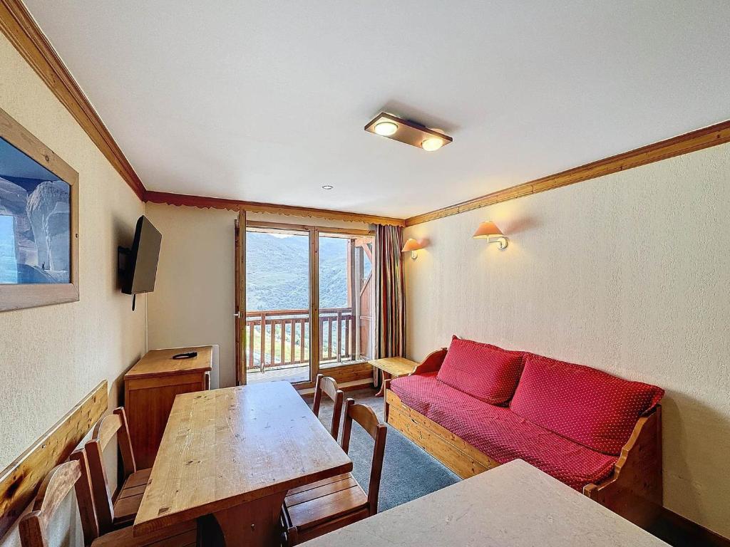 a living room with a red couch and a table at Appartement 2 pièces 4 pers, exposé sud, à côté télécabine des Bruyères - FR-1-178-376 in Les Bruyères
