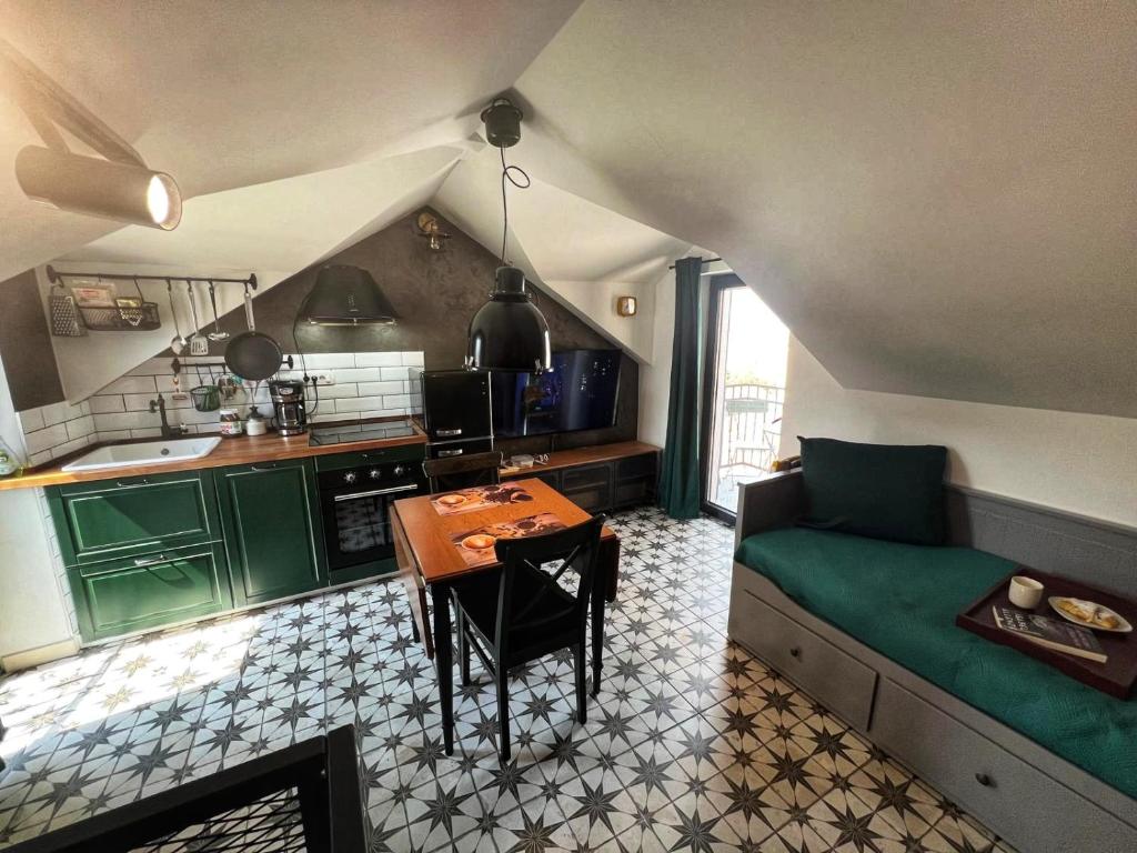a kitchen with a couch and a table in a room at Domus Lapidea in Postira