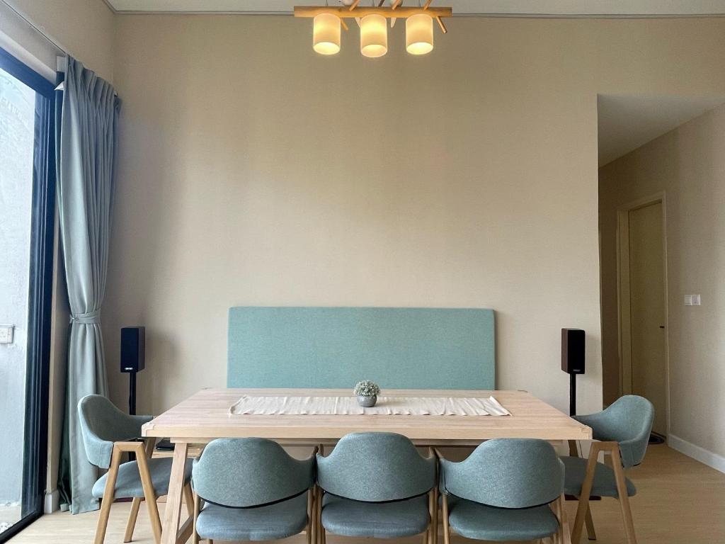 a dining room table with blue chairs around it at Astoria Ampang x Near KLCC TRX BigRoom 12pax in Kuala Lumpur