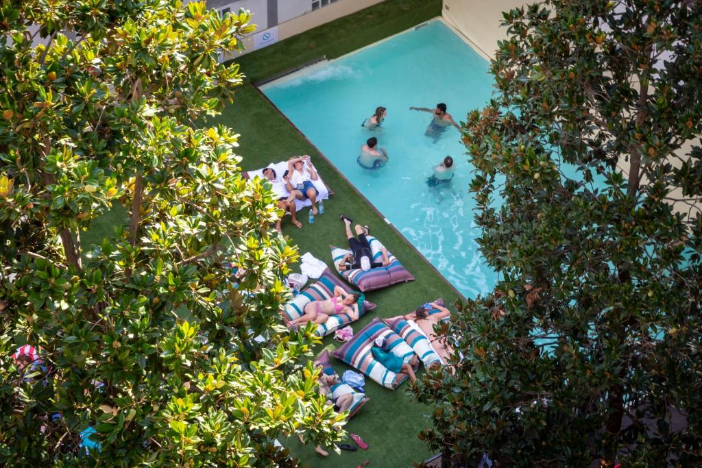 a group of people in the pool at a resort at Plus Florence in Florence