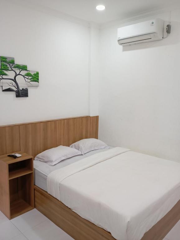 Postel nebo postele na pokoji v ubytování Hotel Bhakti Syariah