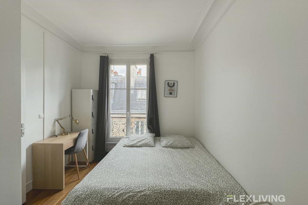 a bedroom with a bed and a desk and a window at Flexliving - room - Lemoine in Paris