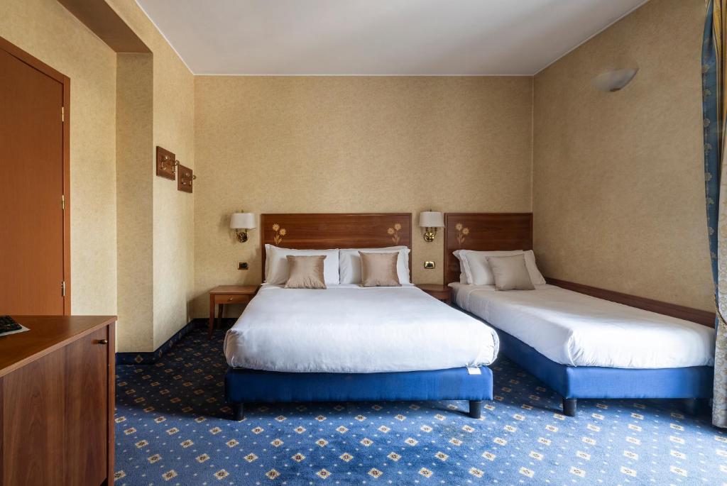 Postel nebo postele na pokoji v ubytování Boutique Hotel Dieci