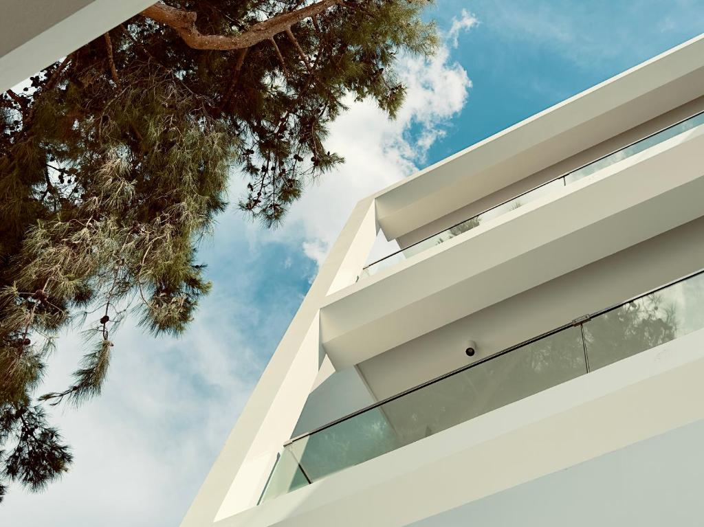 a view of the facade of a house with a tree at The Roc Club, A Grecotel Hotel to Live in Athens