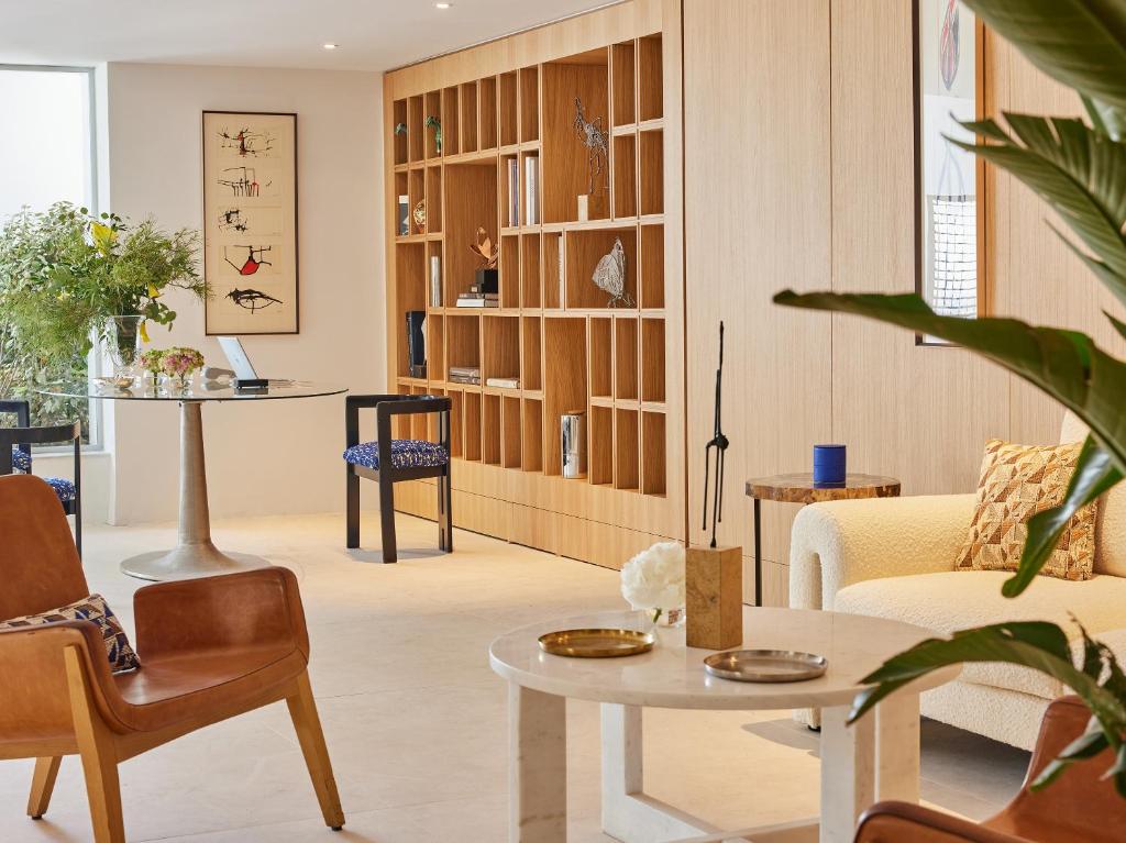 a living room with a couch and a table at The Roc Club, A Grecotel Hotel to Live in Athens