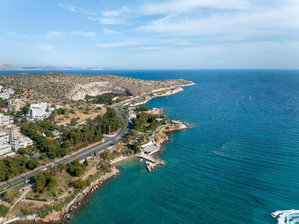 an aerial view of the shoreline of the ocean at The Roc Club, A Grecotel Hotel to Live in Athens