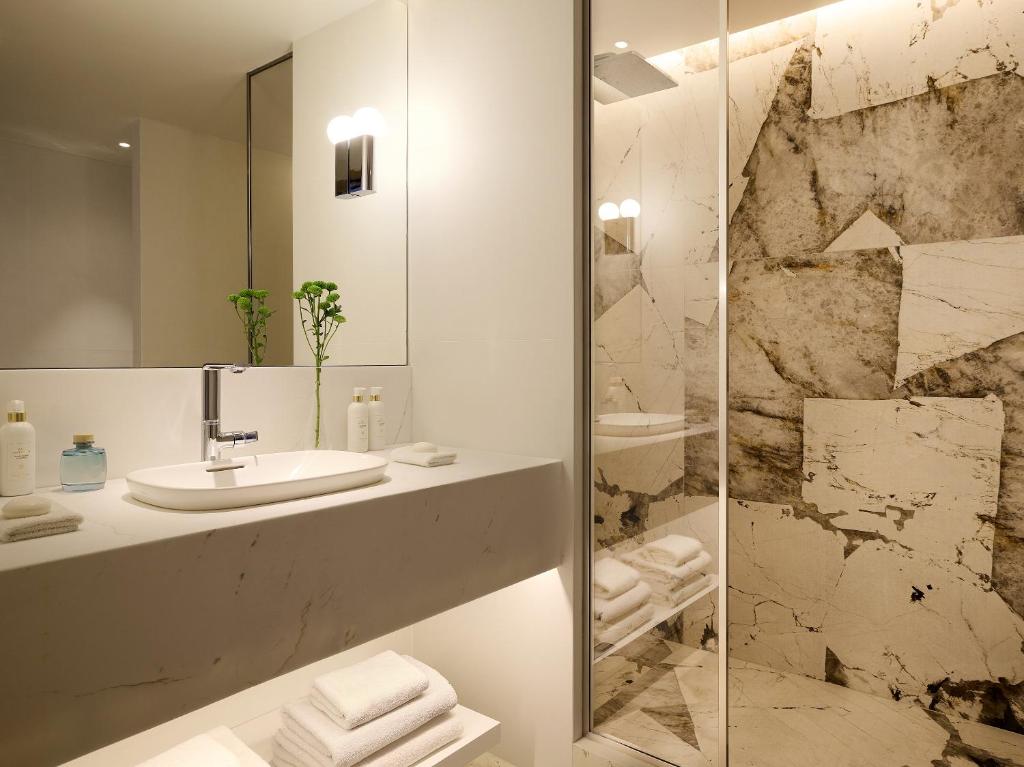 a bathroom with a sink and a shower at The Roc Club, A Grecotel Hotel to Live in Athens