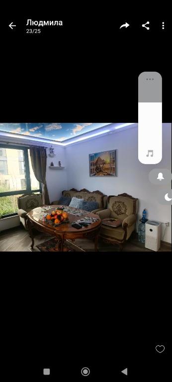 a living room with a couch and a table at Cozy flat Азур in Saints Constantine and Helena