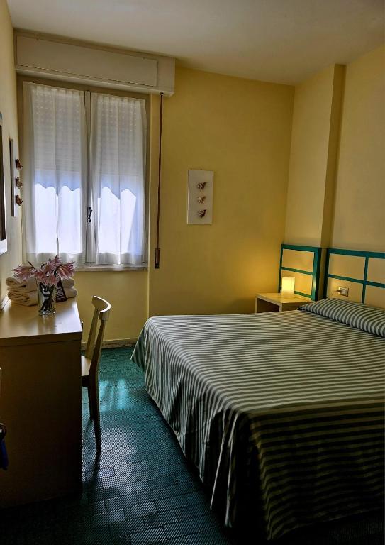 Postel nebo postele na pokoji v ubytování Hotel La Scogliera