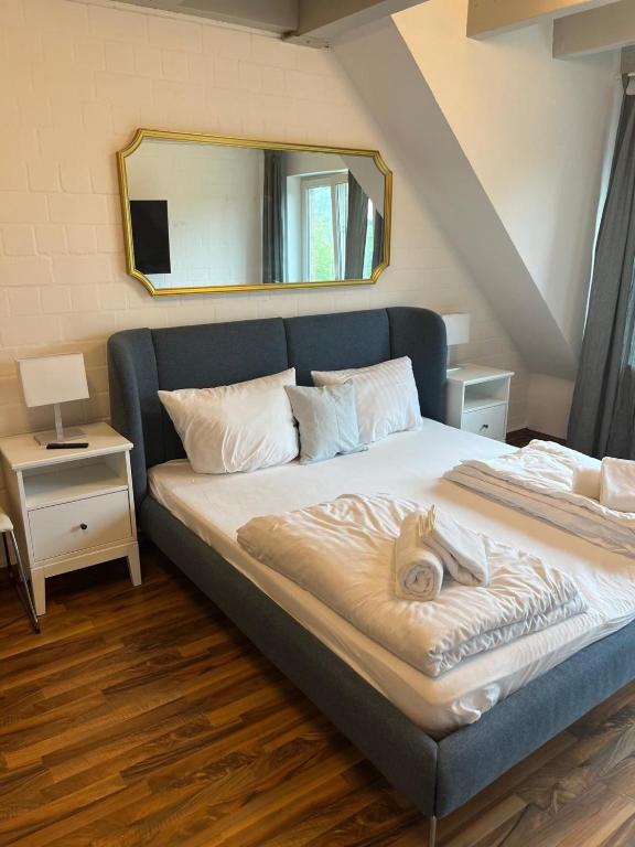 a bedroom with a large bed with a mirror at Alt Mölln, Apartment 11 in Alt Mölln