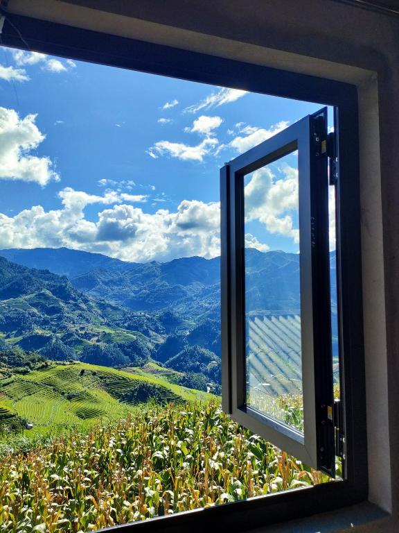 a window with a view of the mountains at Indigenous homestay - Trek & Local Life in Mù Cang Chải