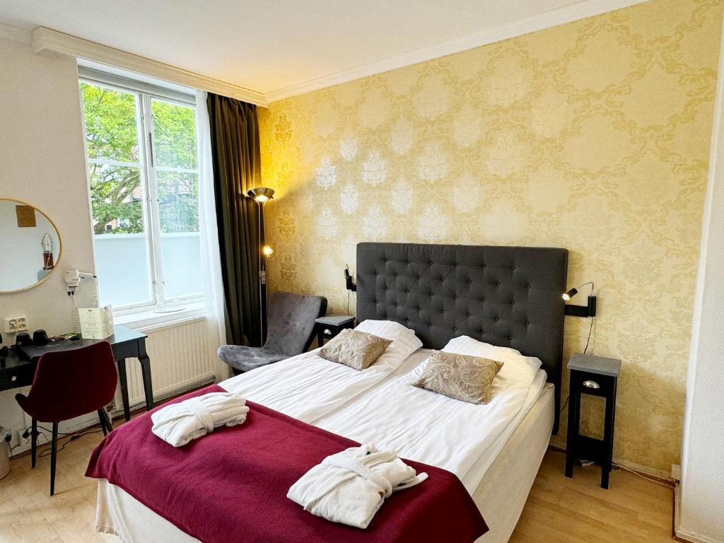 Postel nebo postele na pokoji v ubytování Hotel Concordia