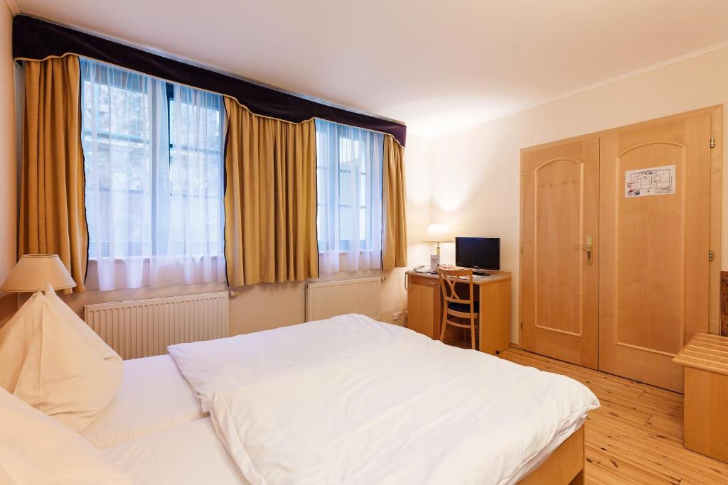 Postel nebo postele na pokoji v ubytování Hotel Maltezský Kříž