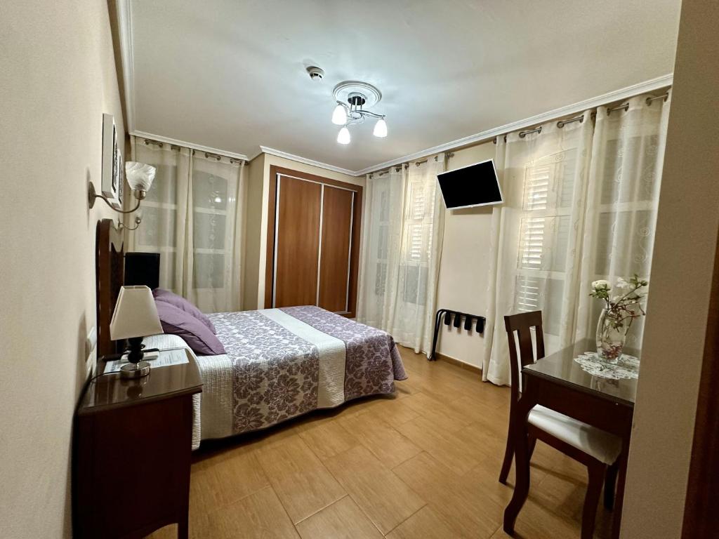Postel nebo postele na pokoji v ubytování Hostal Avenida