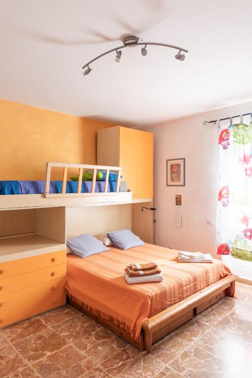 a bedroom with a large bed with orange sheets at Casa di Simone in Scandicci