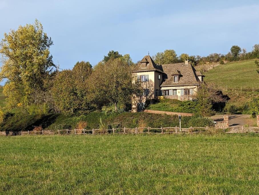 une maison au sommet d'une colline dans un champ dans l'établissement La maison de la Prade, classée 2 étoiles, linge founi, à Clairvaux-dʼAveyron
