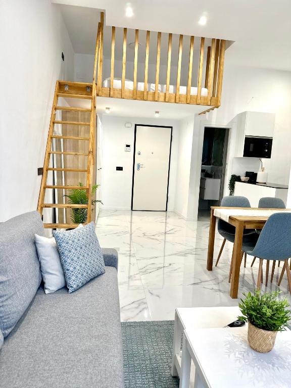 a living room with a couch and a staircase at Mark Suite B8 in Fuengirola