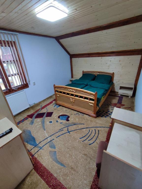 an attic room with a bed and a rug at Guesthouse Regina in Yaremche
