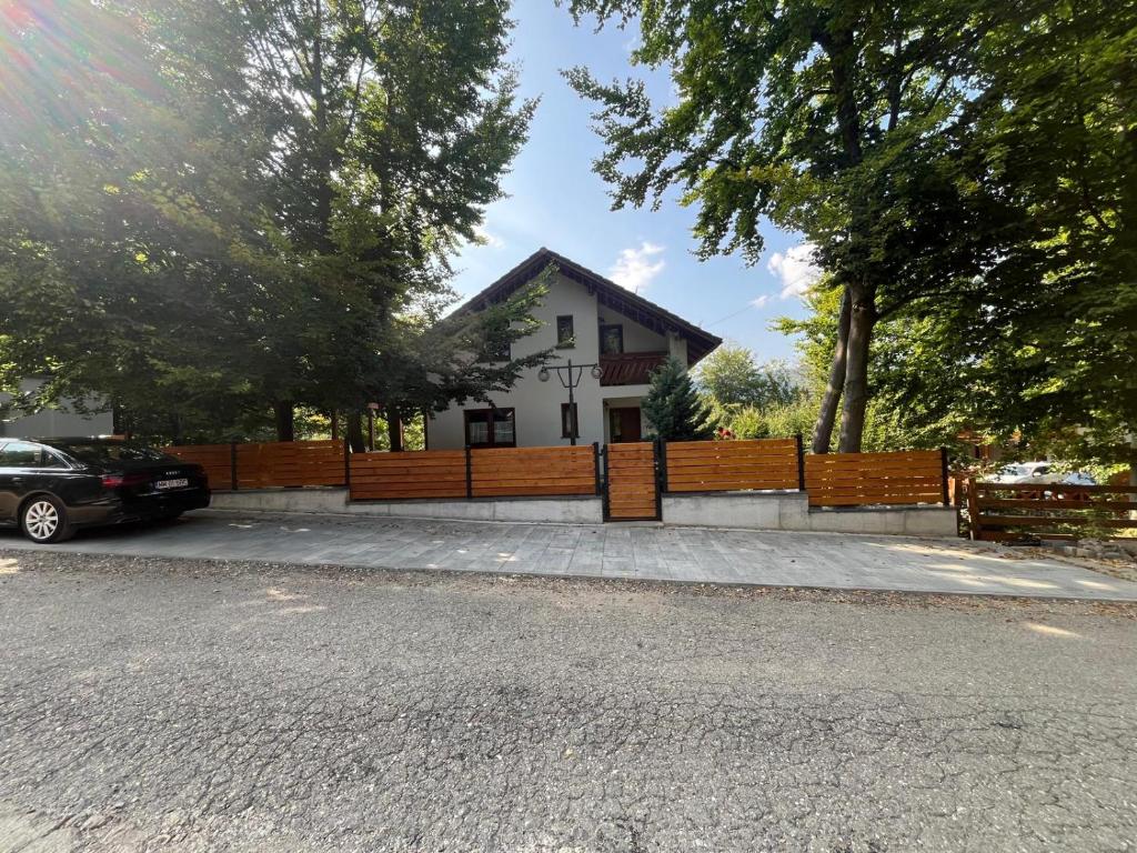 a house with a fence in front of it at Casa de vacanta Mogosa in Baia-Sprie