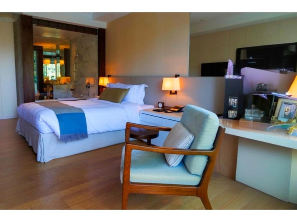 a bedroom with a bed and a chair and a desk at Olive Bay Hotel - Vacation STAY 75564v in Saikai