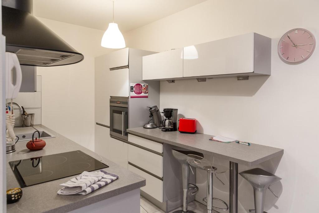 a kitchen with white cabinets and a counter top at Gite hyper centre 10 pers in Colmar
