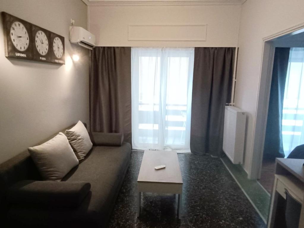 a living room with a couch and a coffee table at Thissio Hideaway Suite in Athens