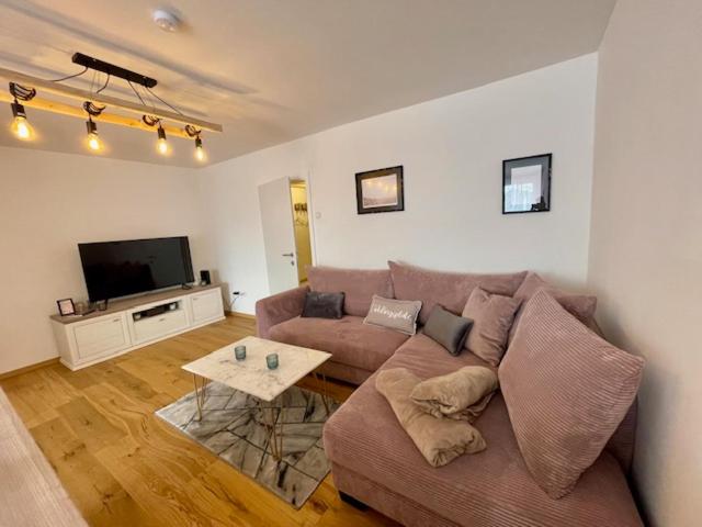 a living room with a couch and a tv at Zentrales City Apartment in Graz