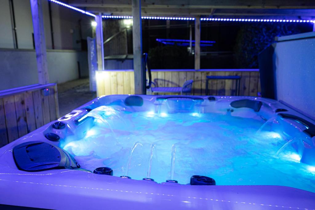 a jacuzzi tub with blue lights in a room at Port Lush in Portrush