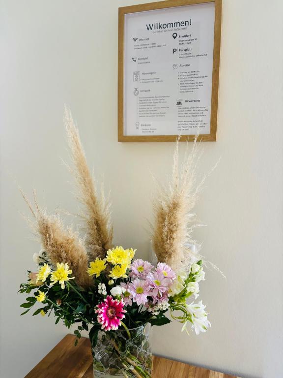 a vase filled with flowers sitting on a table at City Apartments in Erfurt