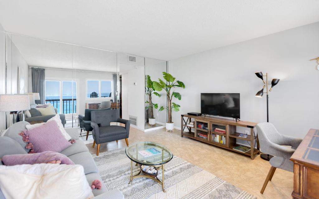 a living room with a couch and a tv at Ocean Breezes by Oversee 30A in Carillon Beach