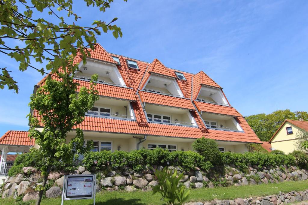 un gran edificio con techo naranja en Hafenhäuser Breege - Ferienwohnung 9 Strandläufer, en Breege