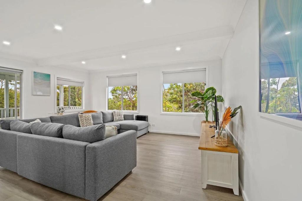a living room with a couch and a table at Aqua Breeze by Experience Jervis Bay in Vincentia