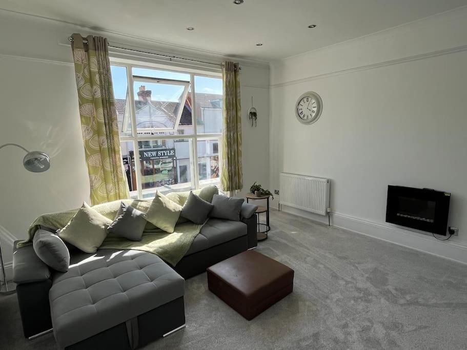 a living room with a couch and a window at Central Two-three bedroom Beach town maisonette in Southsea