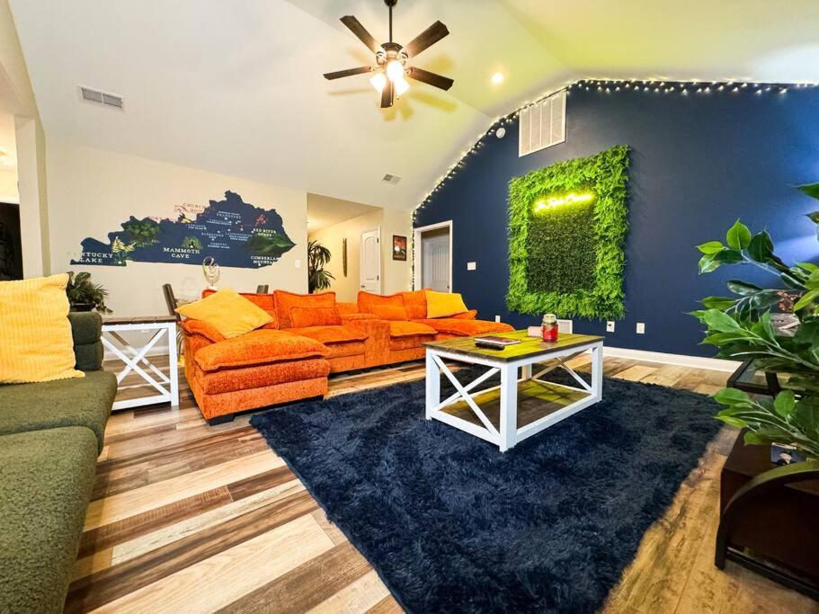 リッチモンドにあるArtsy KY Themed Richmond Gem Sleeps 8 Near Allの青い壁のリビングルーム(オレンジ色のソファ付)