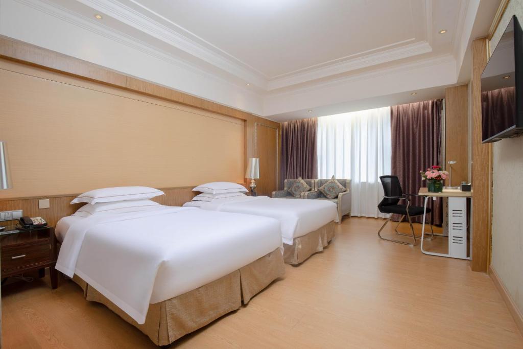 Postel nebo postele na pokoji v ubytování Guangzhou Good International Hotel