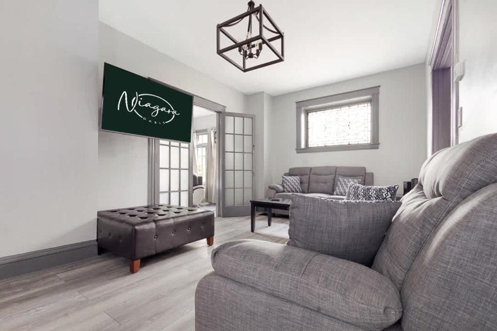 a living room with a couch and a chair at Cozy 4BR 1BA close to the Falls in Niagara Falls