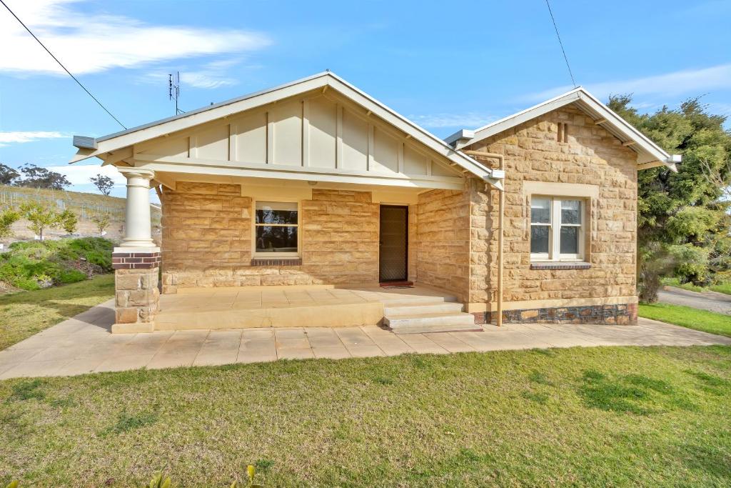 a stone house with a large driveway at Lambert Estate Retreat in Angaston