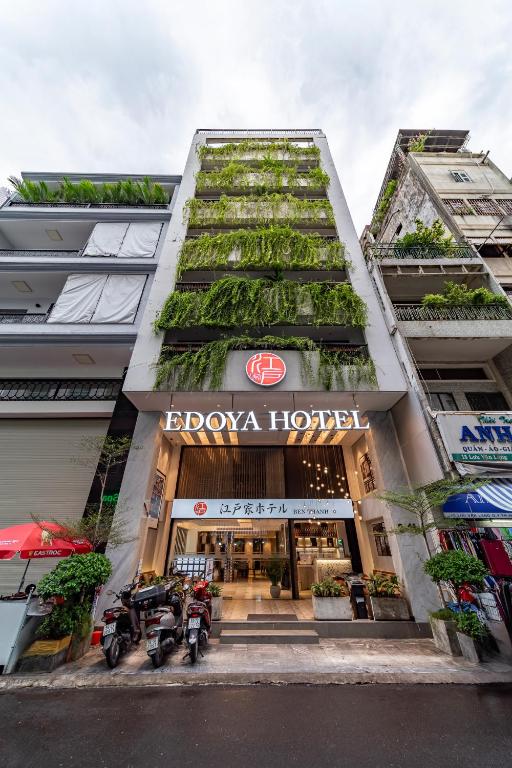 a building with plants on the side of it at Edoya Hotel Ben Thanh in Ho Chi Minh City